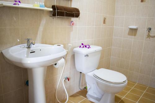 a bathroom with a toilet and a sink at Thai Life Guesthouse Khaolak in Khao Lak