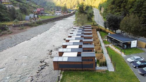a row of shipping containers sitting next to a river at River Side TinyHouse in Çamlıhemşin