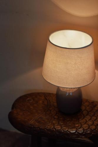 a lamp sitting on top of a table at Dreamers: home & coffee in Xuan An