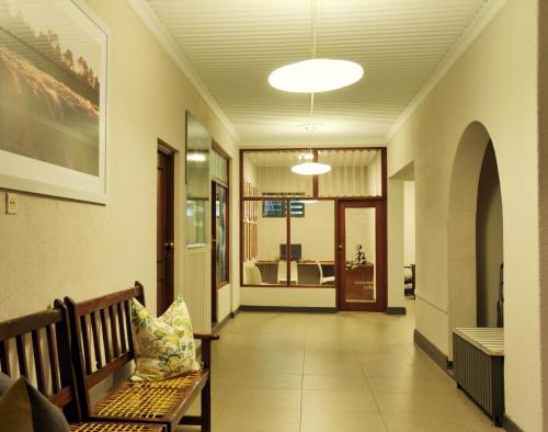 a hallway with a bench and a view of a room at Cresta Sprayview Victoria Falls in Victoria Falls