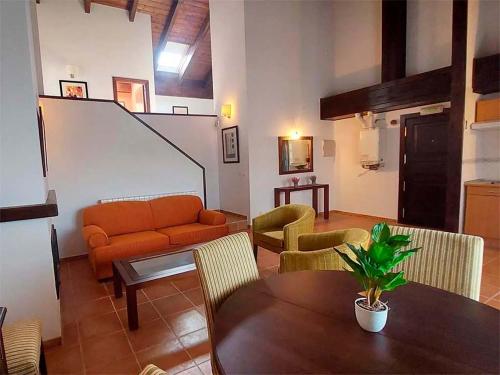 a living room with a couch and a table at Apartamentos Jaca Mirador de Badaguas 3000 in Badaguás