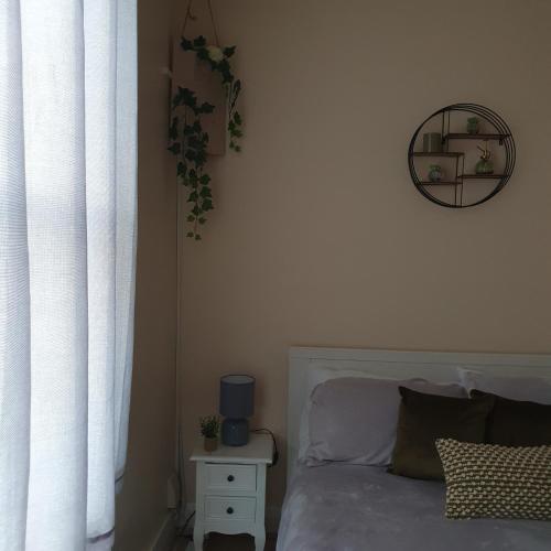 a bedroom with a bed and a clock on the wall at sweet dreams A in London