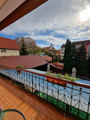a balcony with a view of a city at Pensiunea Korona and Restaurant in Miercurea-Ciuc