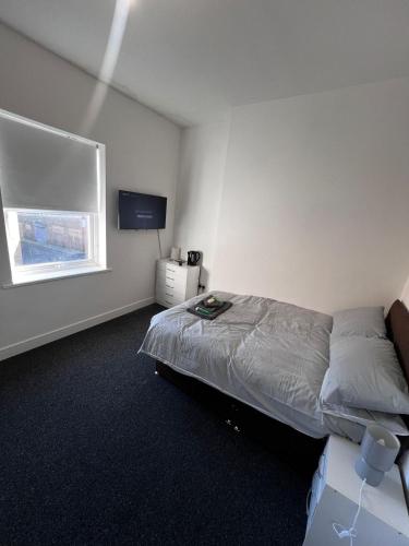 a bedroom with a bed and a window at Serendipity By Habitat101 in Middlesbrough