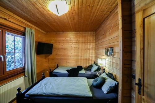 a room with two beds in a log cabin at Bergfreude Chalet in Braunlage