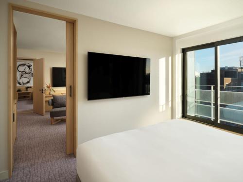 a hotel room with a bed and a flat screen tv at Nobu Hotel London Portman Square in London