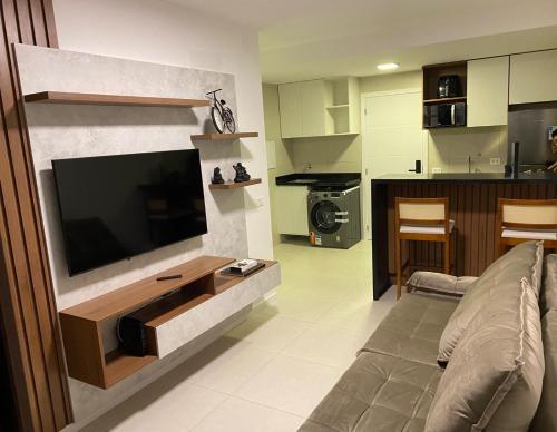 a living room with a flat screen tv on a wall at Studio 1quarto Vista Mar Barra in Salvador