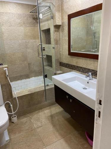 a bathroom with a sink and a shower at شقة in Cairo