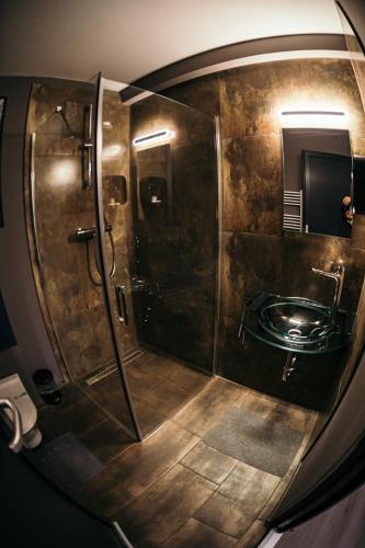 a bathroom with a shower and a sink at Ride More Activity Center in Miercurea-Ciuc