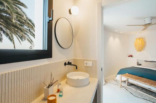 a bathroom with a sink and a mirror at Villa Alma luxe & sea views in Cala Llonga