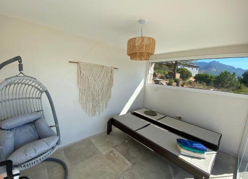 a room with a chair and a table and a window at Fiore di Machja - Moncale in Moncale