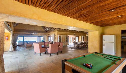 a living room with a pool table in it at Collection Luxury Accommodation: Quinta Do Sol, Vilanculos, Mozambique in Vilanculos