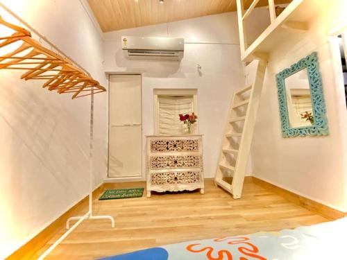 a room with a loft bed and a staircase at Bandra Cottage (With Yard) in Mumbai