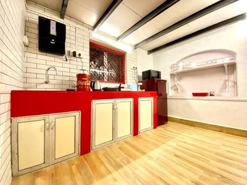 a kitchen with a red counter in a room at Bandra Cottage (With Yard) in Mumbai