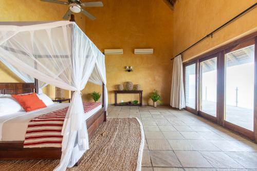 a bedroom with a bed with a canopy at Collection Luxury Accommodation: Quinta Do Sol, Vilanculos, Mozambique in Vilanculos