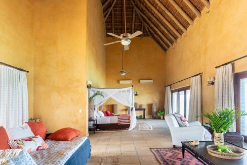 a living room with a couch and a ceiling fan at Collection Luxury Accommodation: Quinta Do Sol, Vilanculos, Mozambique in Vilanculos