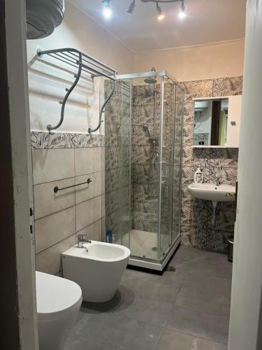 a bathroom with a shower and a toilet and a sink at Villa Cecilia in Pozzuoli