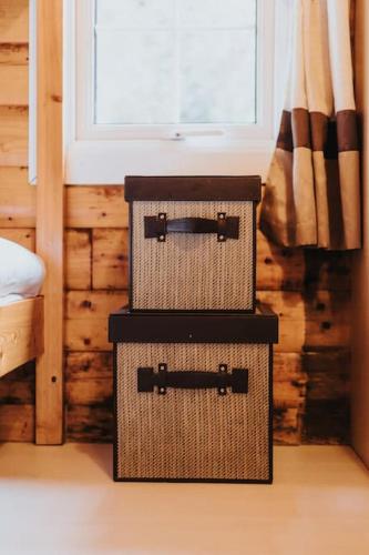 two baskets sitting on top of each other in a bedroom at Rustic Log Cabin in Snowdonia - 2 Bedrooms & Parking in Ffestiniog