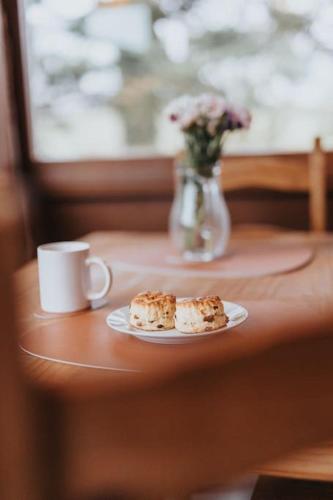 a plate of food and a cup of coffee on a table at Rustic Log Cabin in Snowdonia - 2 Bedrooms & Parking in Ffestiniog