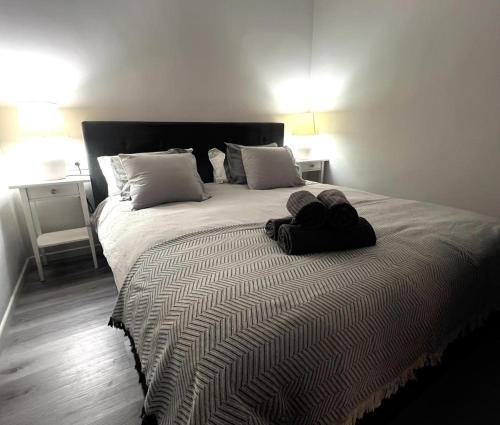 a bedroom with a large bed with two pillows at Grandes Playas Haven in Corralejo