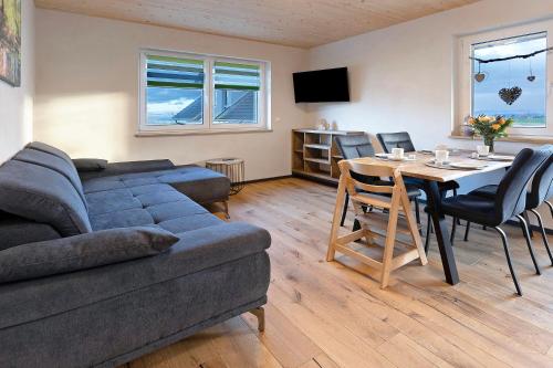 a living room with a couch and a table at Ferienwohnungen Bosserthof in Donaueschingen