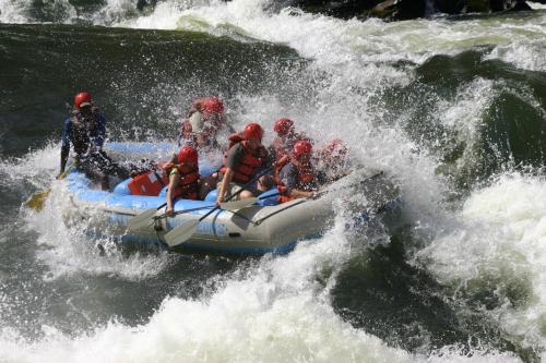 a group of people on a raft in a river at Cresta Sprayview Victoria Falls in Victoria Falls