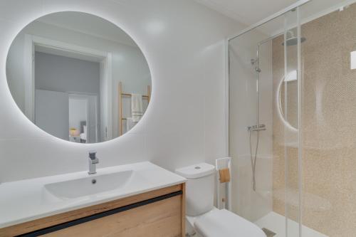 a bathroom with a sink and a mirror at Graça House in Machico