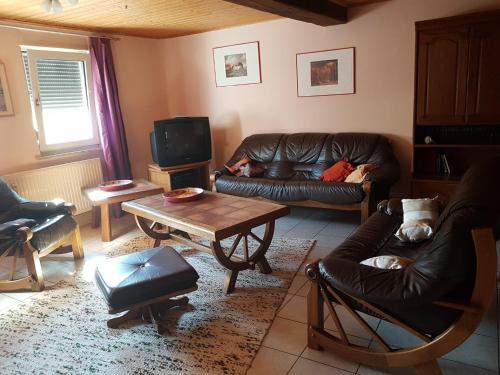 uma sala de estar com um sofá de couro e uma mesa em Scholz 