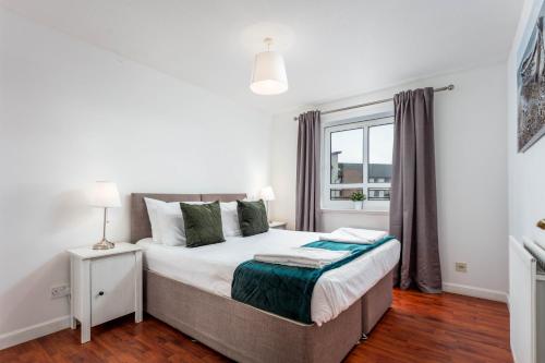 a bedroom with a bed and a window at The Original Donnini Apartment in Ayr