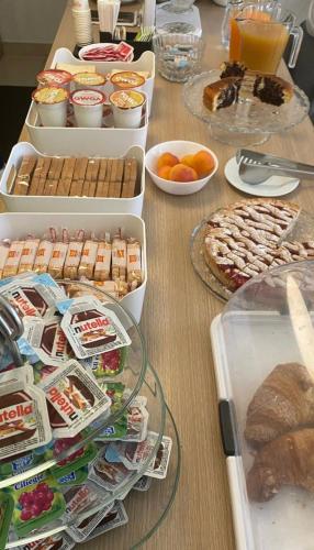 a table with several trays of food on it at San Michele Apartments&Rooms in Catanzaro