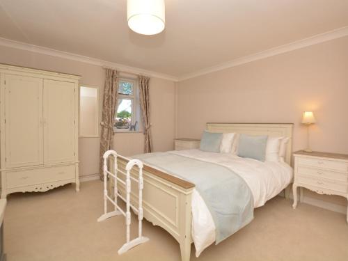a white bedroom with a large bed and a window at 3 Bed in Tansley 57013 in Tansley