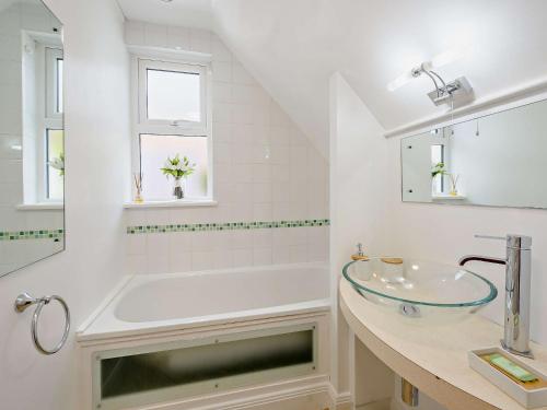 a white bathroom with a tub and a sink at 2 Bed in Bideford 87991 in Parkham