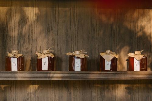 a row of five bottles of chocolate in a shelf at TOKI Retreat Vân Long in Ninh Binh