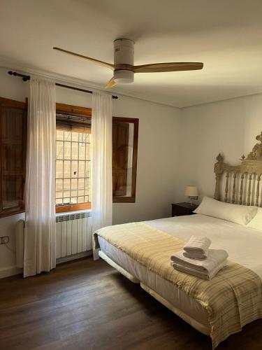 a bedroom with a bed and a ceiling fan at LA CASA DEL JAIME in Mora de Rubielos