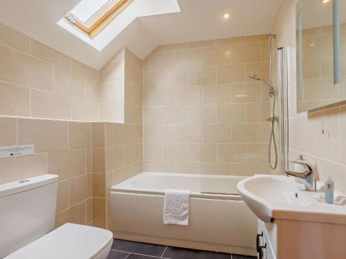 a bathroom with a tub and a toilet and a sink at 3 Bed in Launceston BRWHI in Launceston