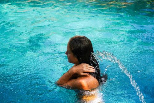a woman in the water in a pool at Ba Be Jungle Houses in Ba Be