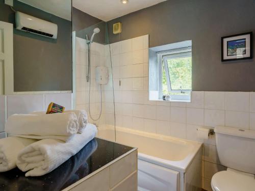 a bathroom with a shower and towels on a counter at 2 bed in Clitheroe 89536 in Chipping