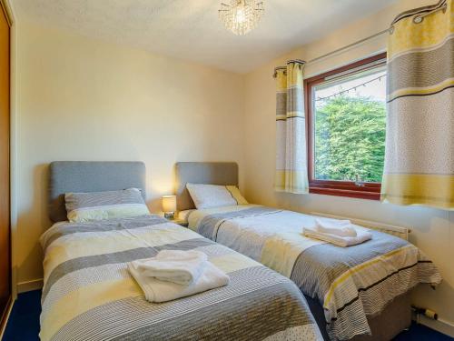 two beds in a room with a window at 2 bed property in Nairn The Highlands 89176 in Nairn