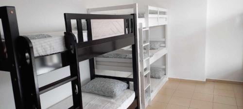 a black bunk bed in a small room at JBR Beach Synergy Inn in Dubai