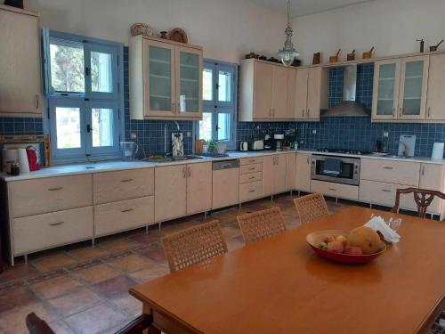 a kitchen with a table with a bowl of fruit on it at Margouno Eco-Villa, Eggares, Naxos in Eggares