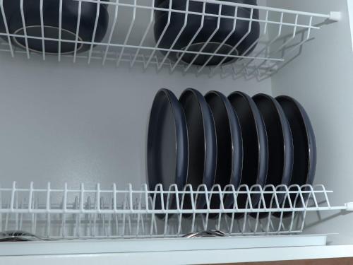 a closet with black plates on a shelf at Евродвушка в ЖК Каратал in Kostanay
