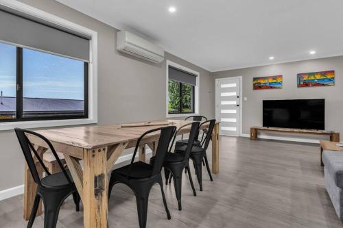a dining room with a wooden table and chairs at JackEllie Lodge - Pets welcome in Eden
