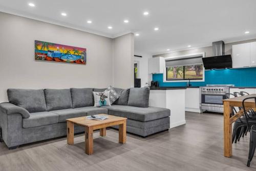 a living room with a couch and a table at JackEllie Lodge - Pets welcome in Eden