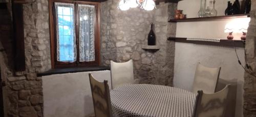 a dining room with a table and a window at Casatorre Castagnedola in Zocchetta
