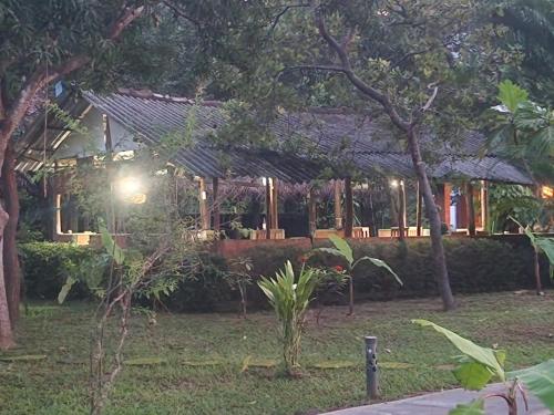a house with a garden in front of it at Sigiriya Cottage in Sigiriya