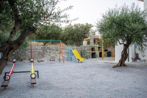 a playground with two swings and a swing at Villa Nontas Ntina with Private Pool & Playground in Rethymno Town