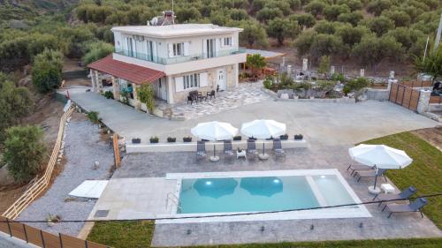 an aerial view of a house with a swimming pool at Villa Nontas Ntina with Private Pool & Playground in Rethymno Town