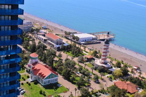 an aerial view of a beach with a lighthouse at Orbi City on the Beach in Batumi