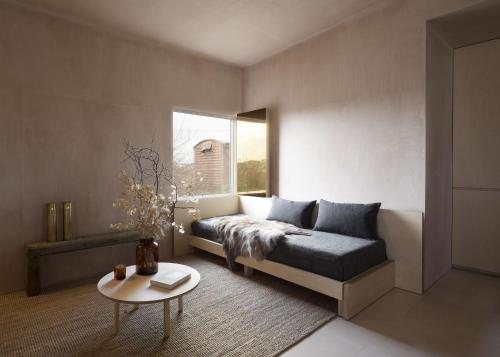 a bedroom with a bed and a table and a window at Channel View, Dungeness by Bloom Stays in Dungeness