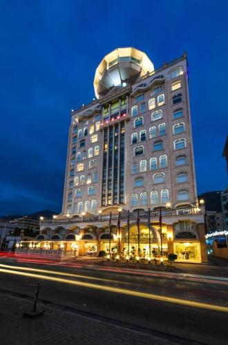 a large building with a circle on the top of it at Portaluna Hotel & Resort in Jounieh